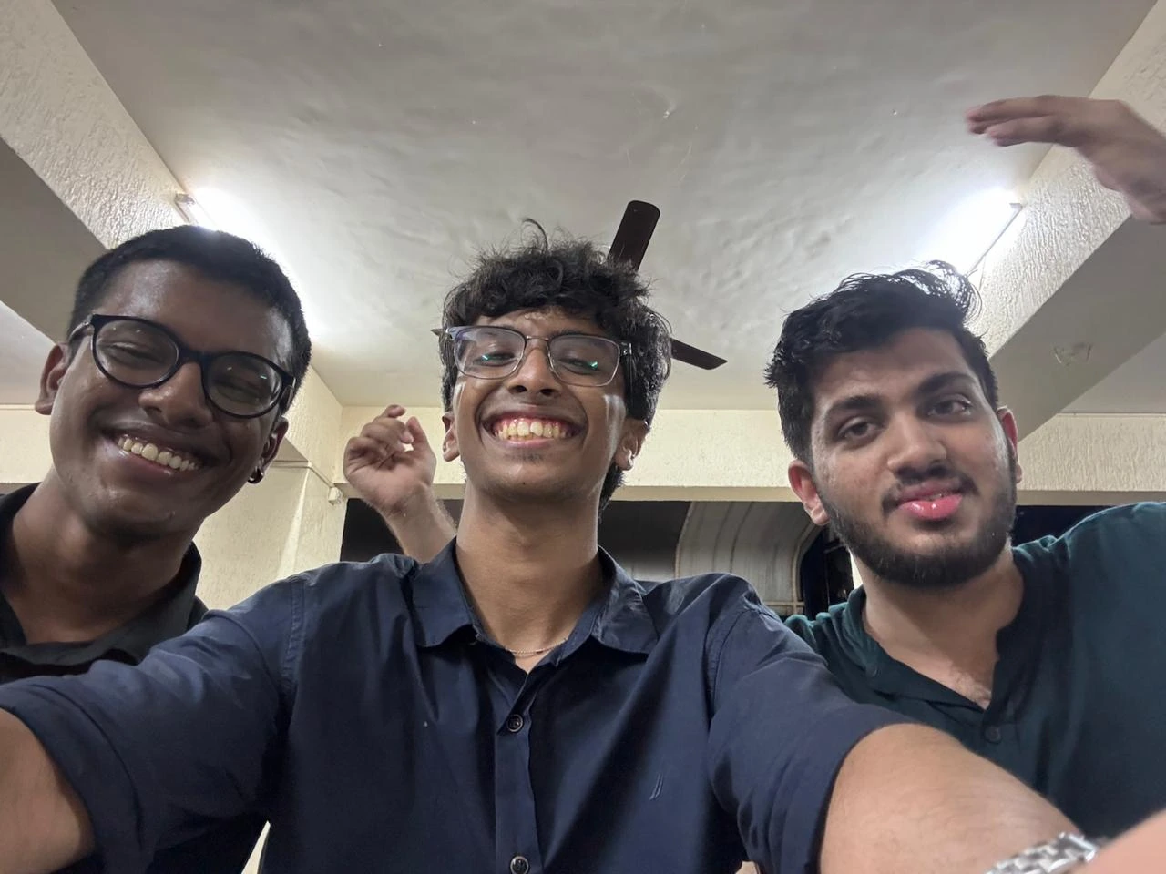 Three friends leaning in for a selfie
