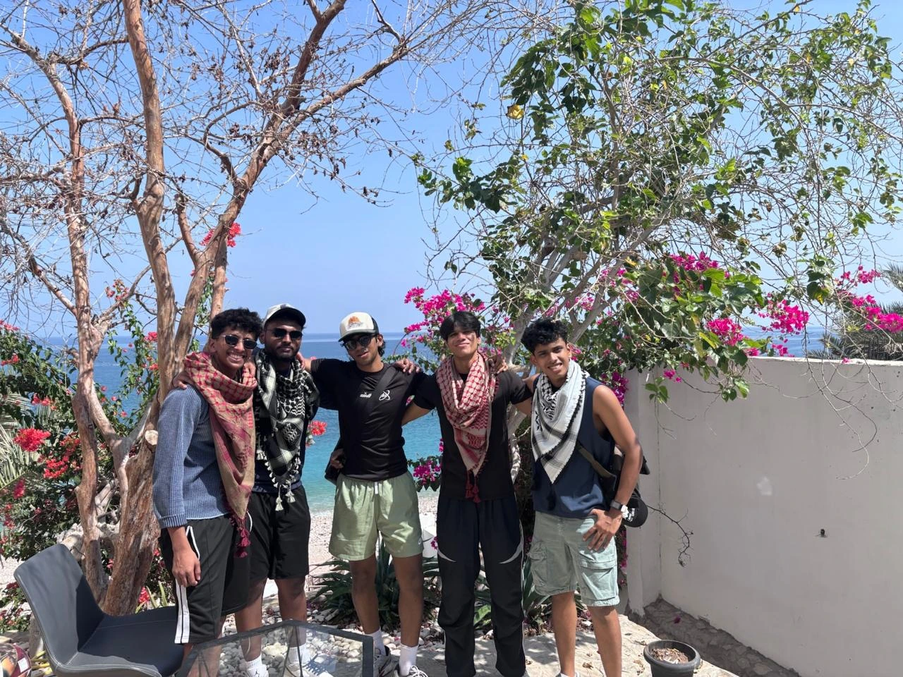 A group photo on a trip, everyone squinting into the sun