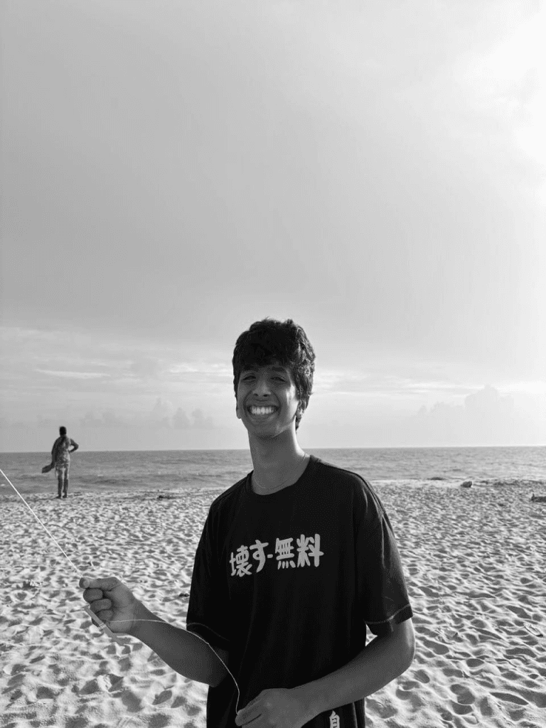 Melvis on a beach, grinning, holding a kite string. Pointing at the photo shows an X-ray of his skeleton.