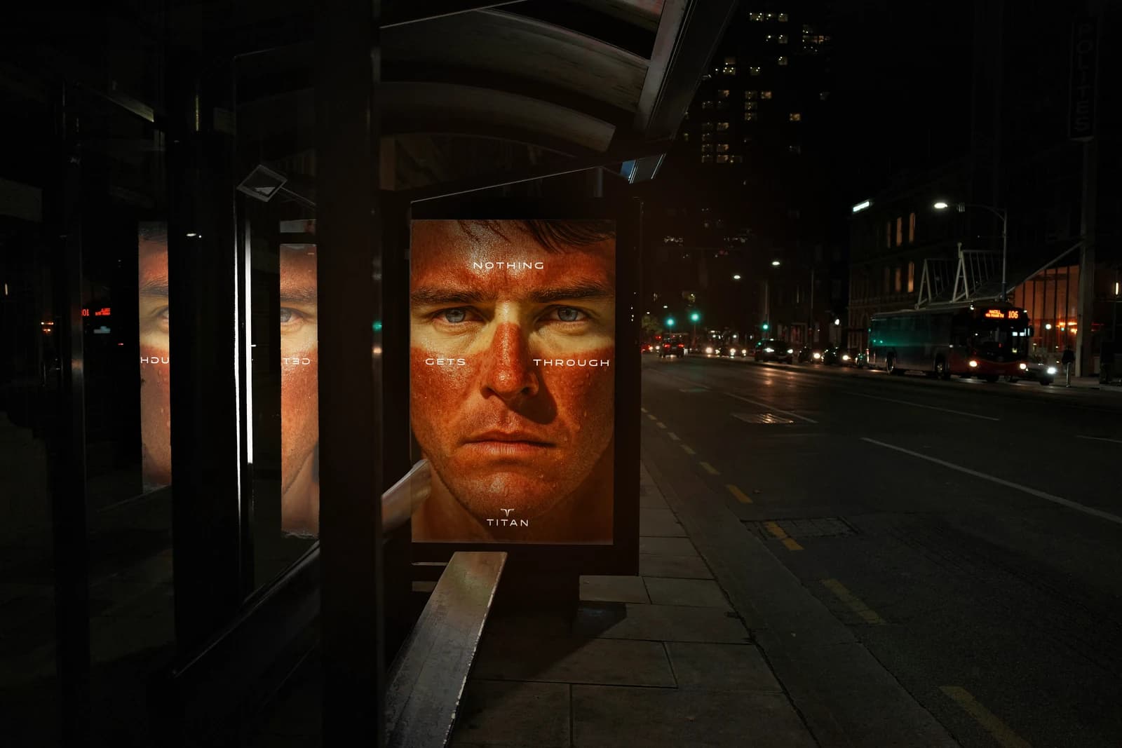 The NOTHING GETS THROUGH poster lit in a bus shelter on a dark street, a sunburnt face filling the frame