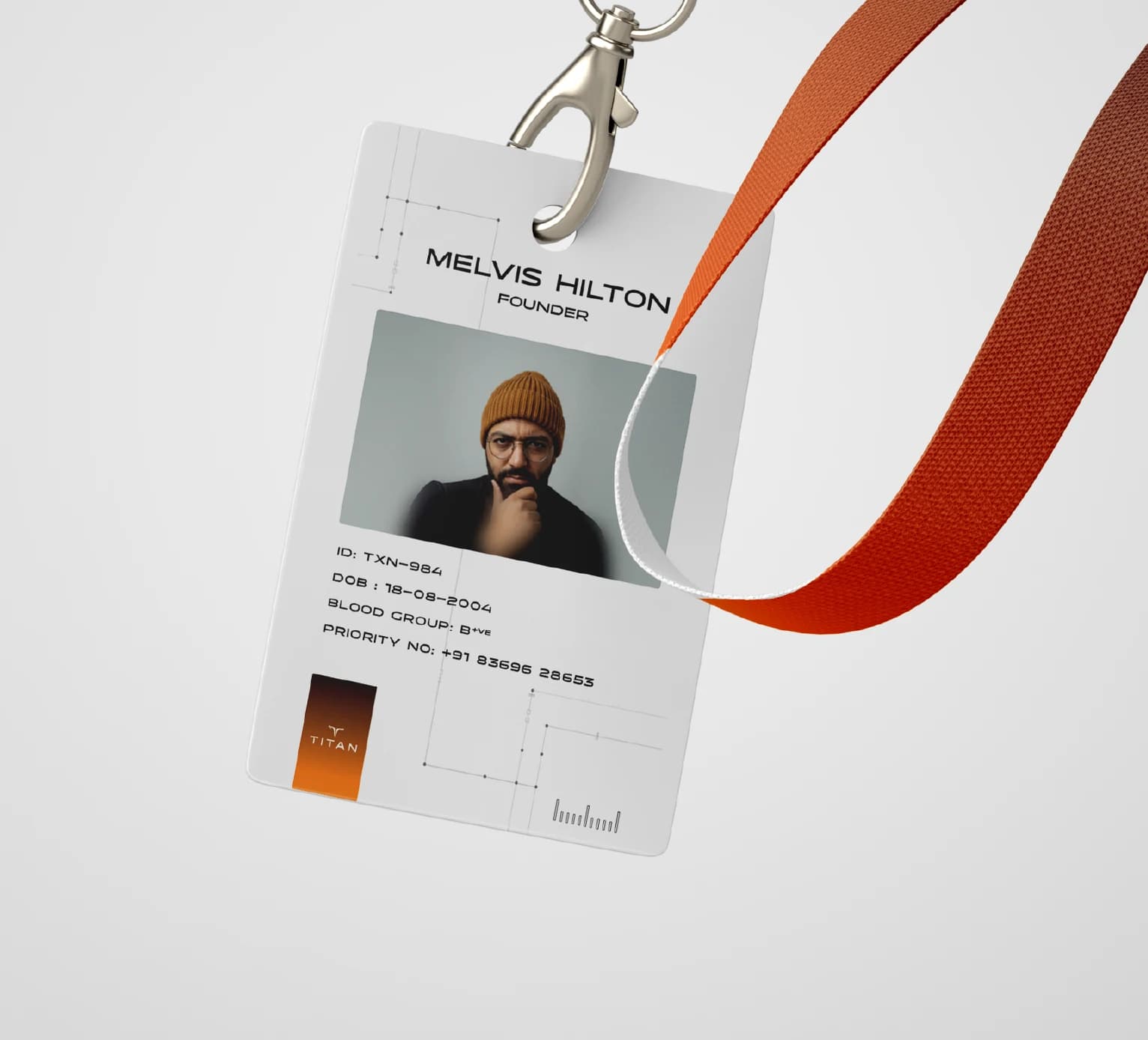 A staff ID card hanging from an orange lanyard, the mark in an amber block at its foot